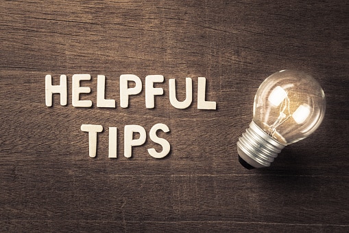 words 'helpful tips' in ivory next to a glowing light bulb against a dark brown wood piece. Helpful tips on choosing a water well driller.