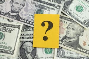 Question mark on dollar banknotes. Cost of Drilling a Water Well - JB Water Well.